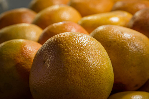 A full frame photograph of a display of oranges for sale on a market stall - Foto, imagen