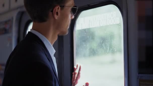 A handsome young intern rides the subway to work or an interview dressed in a business suit. First day at work concept. Prores 422 - Filmmaterial, Video