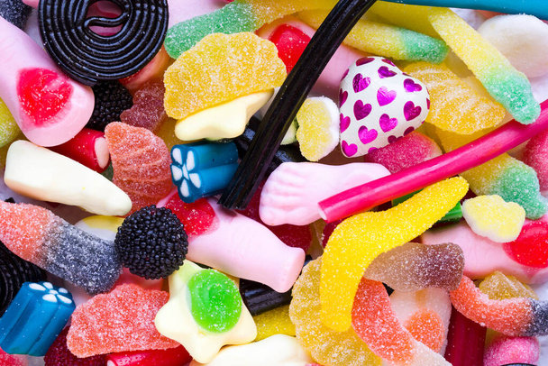 background of sweets of various colors and flavors - Foto, afbeelding