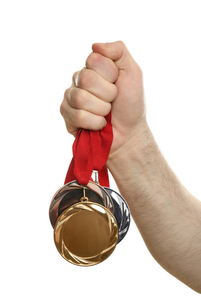 Man holding medals on white background, closeup. Space for design - Photo, Image