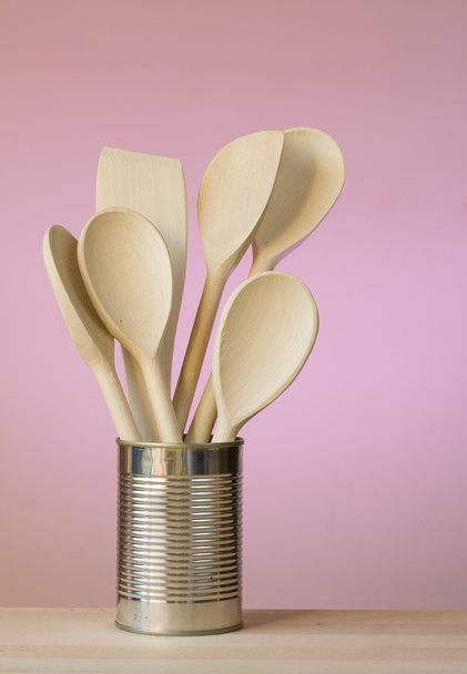 Kitchen utensils in a can with wall behind - Photo, Image