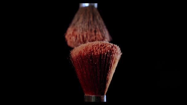 Two Make-up brush with powder on black background with sunlight Colour Paint Concept Slow Motion. V2 - Séquence, vidéo