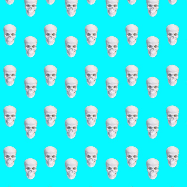 Σύγχρονο κολάζ. Απρόσκοπτη μοτίβο των λευκών κρανίων σε μπλε φόντο - Φωτογραφία, εικόνα