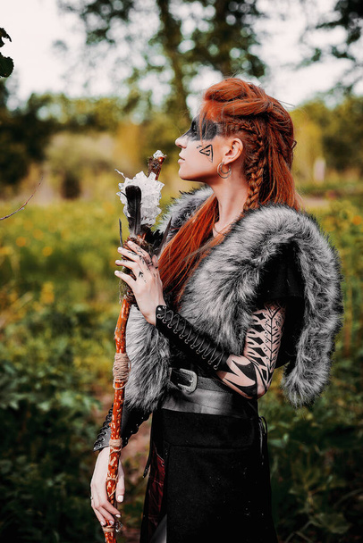 Girl in ethnic scandinavian costume in the forest - Fotó, kép