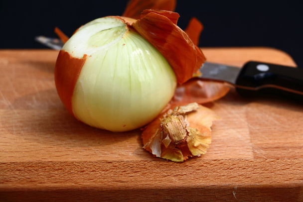 Peeled onion on a cutting board - Photo, Image