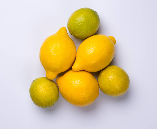 Close up of citrus fruits lemon and lime isolated on white background. - Photo, image