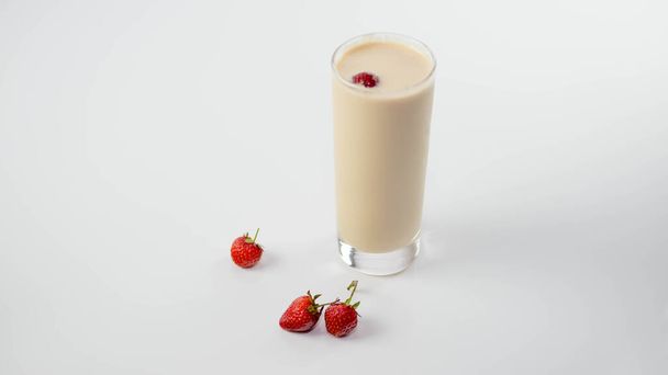 Yogurt in a glass with strawberries,fruit milk drink,on a white background - Фото, зображення