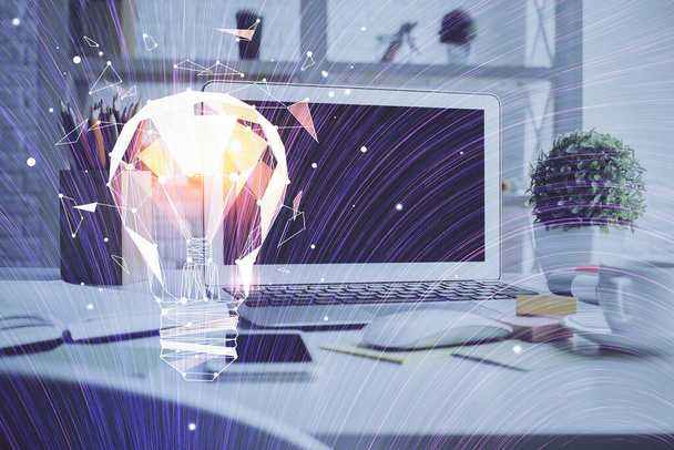 Computer on desktop in office with bulb icon hologram. Double exposure. Concept of idea. - Foto, Bild