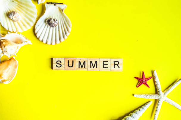 Summer frame with sea stars and shells on bright yellow  background with copy space - Foto, Imagen
