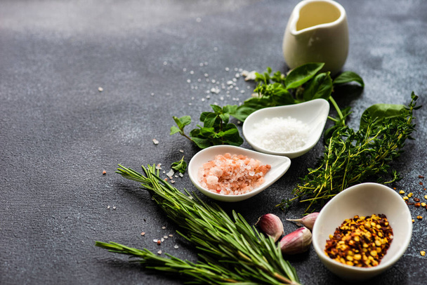 Variety of spices and herbs as a cooking frame on stone background with copy space - Photo, Image