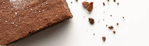 top view of delicious brownie piece on white background, panoramic shot - Photo, Image
