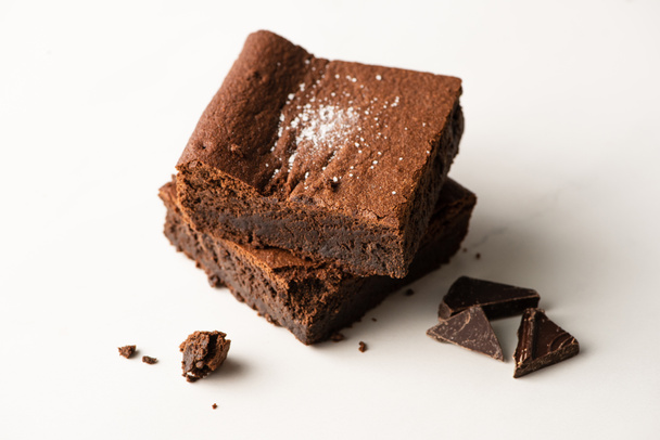 delicious brownie pieces with chocolate on white background - Φωτογραφία, εικόνα
