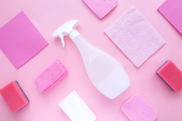 Detergents and cleaning products agent, sponges, napkins and rubber gloves, pink background. Top view - 写真・画像