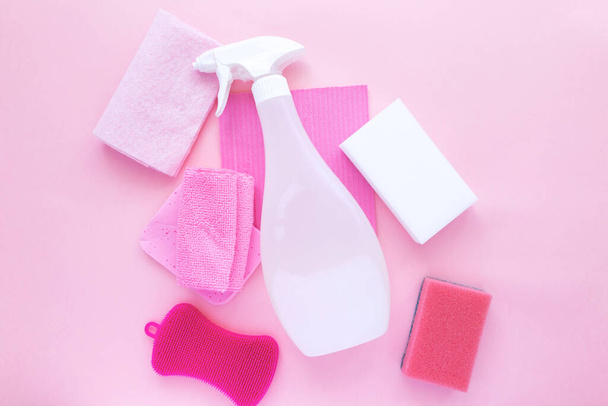 Detergents and cleaning products agent, sponges, napkins and rubber gloves, pink background. Top view - Photo, image