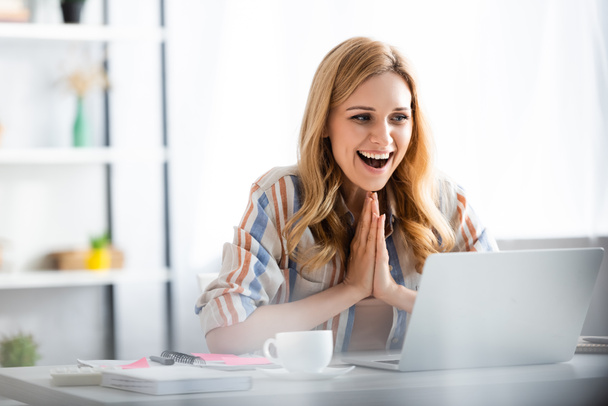 Selective focus of pretty woman laughing and smiling during webinar - Photo, Image