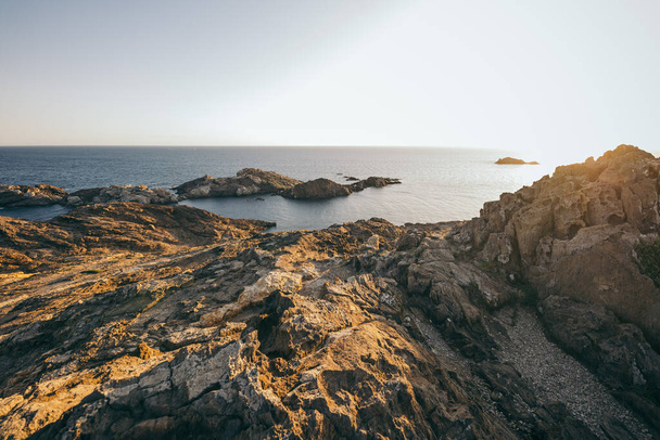 A close up of a rock near the ocean - Fotoğraf, Görsel