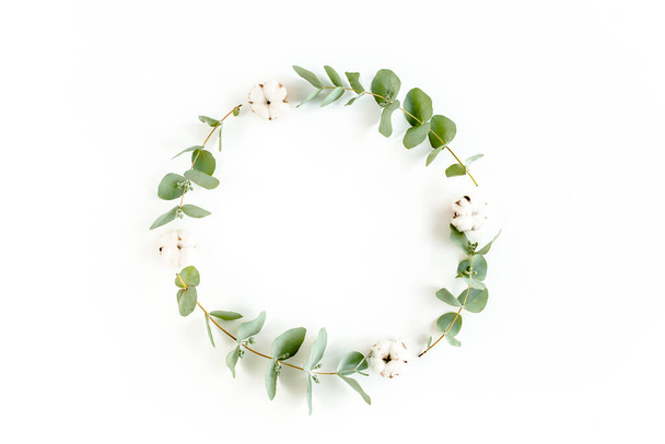 Wreath frame made of branches eucalyptus, leaves and cotton isolated on white background. flat lay, top view - Photo, Image