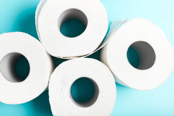 Four white toilet paper on a blue background - Photo, Image