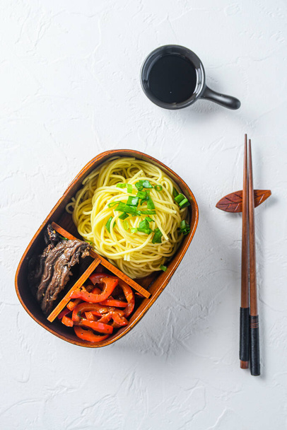 Bento beef noodles lunch box top view on white table. High quality. - Photo, Image