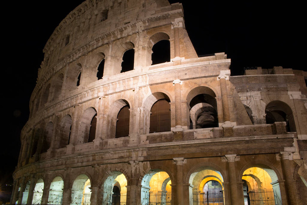 View of illuminated Colosseum at night in Rome - Фото, изображение