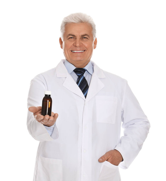Senior pharmacist with syrup on white background - Photo, Image