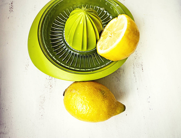 Lemon squeezer, easy manual kitchen toool to collect the juice of the fruits - Photo, Image