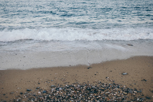 A sandy beach next to the ocean - Photo, image