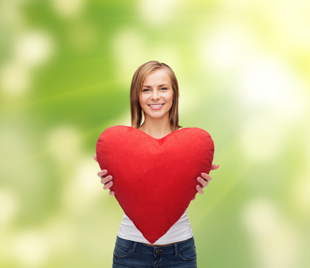 Smiling woman in white t-shirt with heart - Foto, Imagen