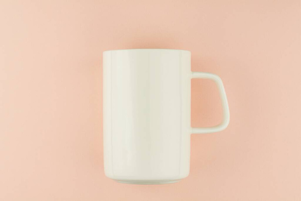 white ceramic coffee cup on pink background. - Foto, imagen