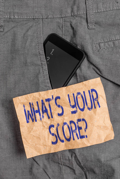 Writing note showing What S Your Score Question. Business photo showcasing Tell Personal Individual Rating Average Results Statistics Smartphone device inside trousers front pocket note paper. - Photo, Image
