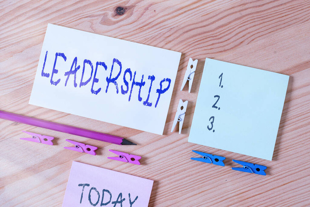 Word writing text Leadership. Business concept for art of motivating to act toward achieving a common goal Colored clothespin papers empty reminder wooden floor background office. - Photo, Image