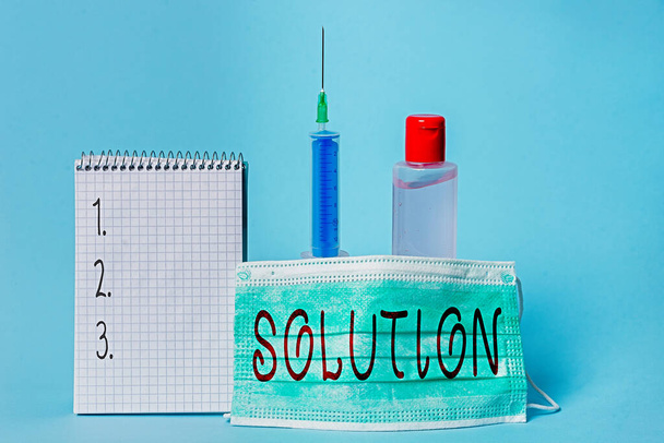 Conceptual hand writing showing Solution. Business photo showcasing the ways to solve a problem or tackle a difficult situation Set of medical equipment with notepad for health assessment. - Photo, Image