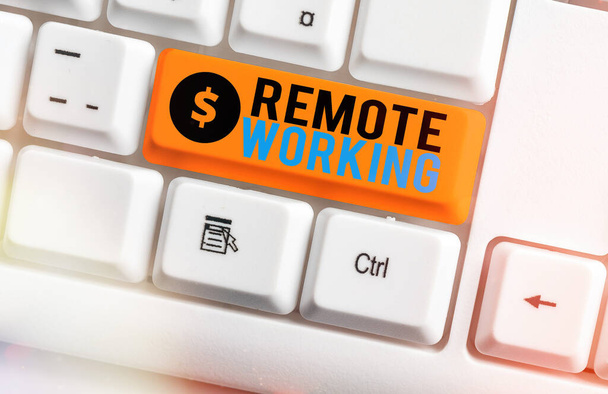Text sign showing Remote Working. Conceptual photo style that allows professionals to work outside of an office White pc keyboard with empty note paper above white key copy space. - Photo, Image
