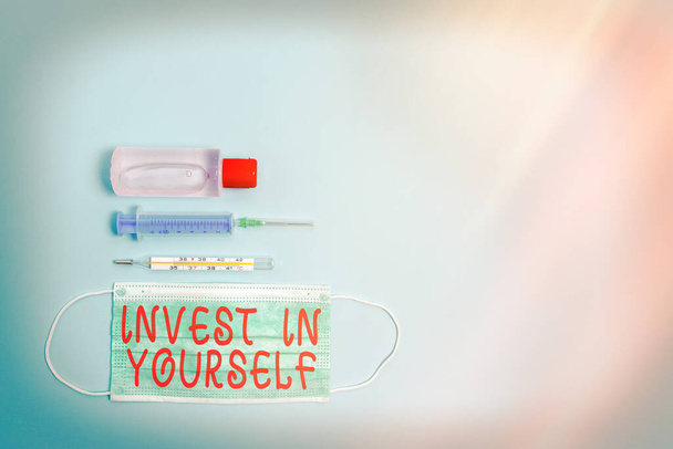 Text sign showing Invest In Yourself. Conceptual photo Improve your Skills take courses Do masters Scholarship Primary medical precautionary equipments for health care protection. - Fotoğraf, Görsel