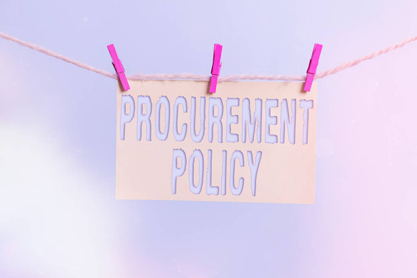 Word writing text Procurement Policy. Business concept for govern choice of suppliers used to tell their suppliers Clothesline clothespin rectangle shaped paper reminder white wood desk. - Photo, Image