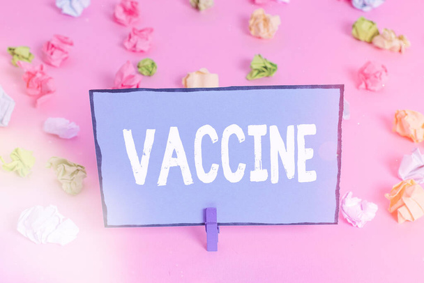 Writing note showing Vaccine. Business photo showcasing preparation of killed microorganisms or living attenuated organisms Colored crumpled papers empty reminder pink floor background clothespin. - Photo, Image