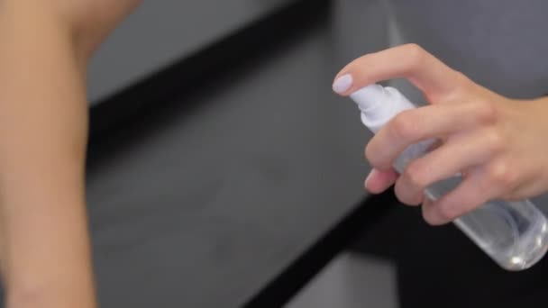 lady hand holds transparent bottle and sprays sanitizer - Video