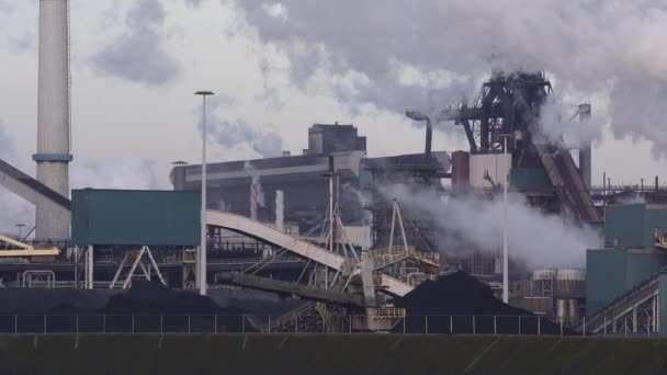 Factory Tata Steel with smoking chimneys on a sunny day, IJmuiden, The  Netherlands Stock Photo