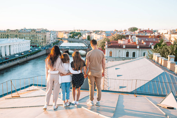 Family on rooftop enjoying with view of beautiful sunset in Sankt Petersburg in Russia - Zdjęcie, obraz
