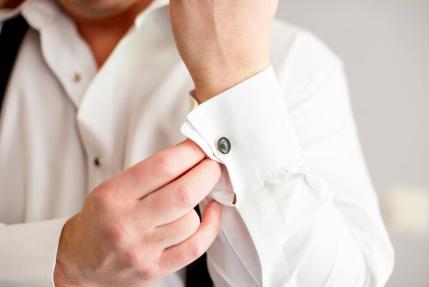 Cufflinks putting on the skirt during groom getting ready morning. Cufflink for wedding marriage ceremony - Foto, Imagen