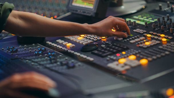 Audio Engineer, Musician, Artist Works in the Music Record Studio, Control Desk Mixer. Hands Touching Switchers, Buttons, Faders, Sliders, Motorized Faders Move, Record, Play Hit Song. Close-up - Zdjęcie, obraz