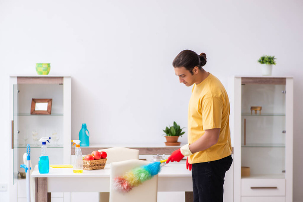 Young male contractor cleaning the house - Foto, Imagem