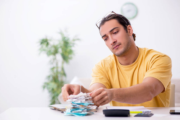Young man in budget planning concept - Photo, Image