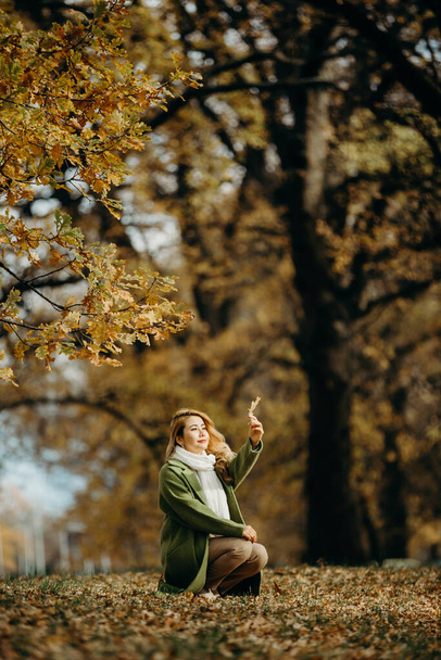 Beautiful Autumn Asian woman with Autumn Leaves on Fall Nature Background. - Φωτογραφία, εικόνα