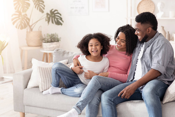 Boldog afrikai család, anya apa és lánya jól érzik magukat otthon. - Fotó, kép