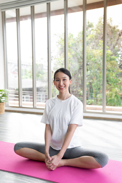 Portrait young asian woman hold yoga mat after finished class with copy space - Foto, imagen