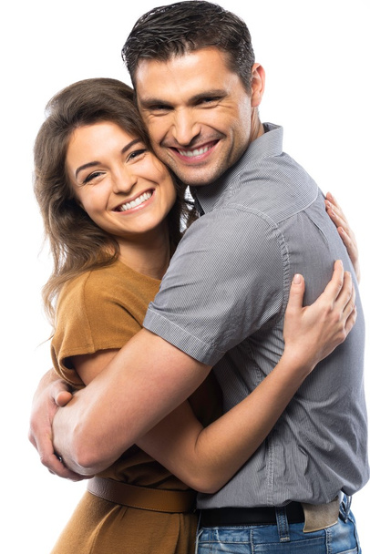 Happy couple in shirt and dress hugging isolated on white - Fotó, kép