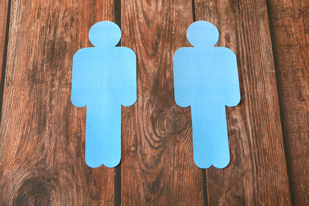 Two blue people from paper sign on wooden background, lgbt concept - Photo, Image