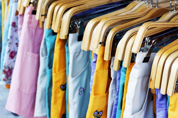 Shop pants hanging on a rack market. - Photo, Image