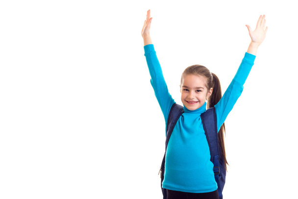 Happy schoolgirl with bag with hands up - Foto, immagini